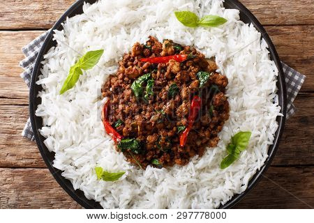 Stir Fry Basil Chicken With Chili Pepper And Soy Sauce With A Side Dish Of Rice Close-up On A Plate.