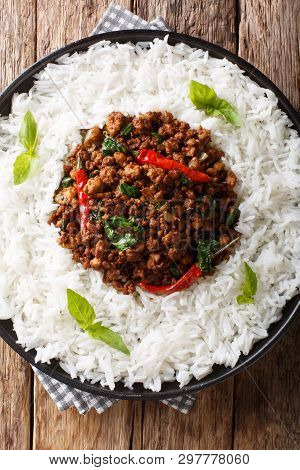 Stir Fry Basil Chicken With Chili Pepper And Soy Sauce With A Side Dish Of Rice Close-up On A Plate.