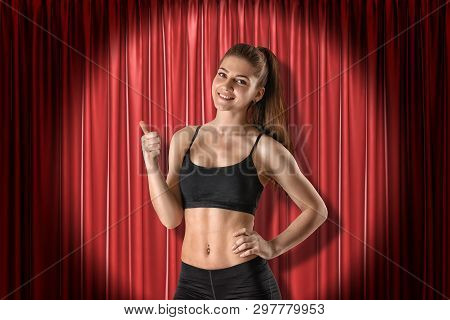 Young Fit Smiling Girl In Sport Crop Top And Shorts Standing In Half-turn, Looking At Camera And Doi