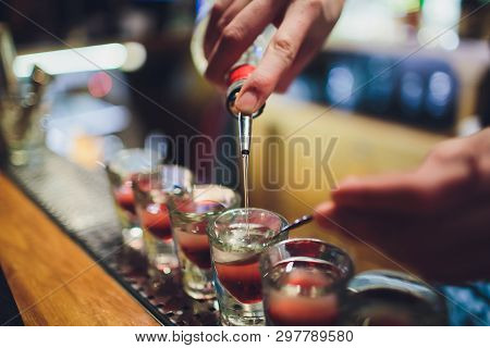 Bartender Man Making Hot Alcohol Shots On The Bar In The Pub With A Professional Burner. The Bartend