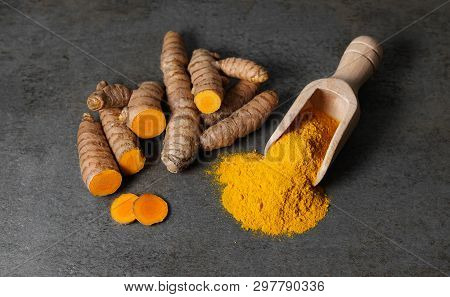 Turmeric Powder Healthy Spice Asian Food Close Up Top View Of Turmeric Root Sliced And A Wooden Bail