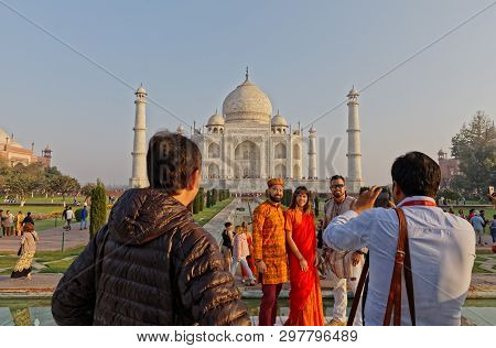 Agra, India - March 5 2018: Tourists Sighteseeing, Exploring And Admiring Famous The Taj Mahal