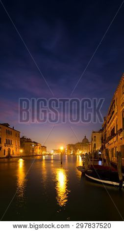 A Lantern On The Grand Canal In Venice, Italy. It Makes The Water Look, Like It Is On Fire.