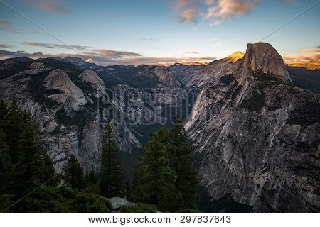 The Light Of The Sunset Shines Over The Half Dome In The Yosemite National Park.