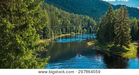 Scenic River Kayak Trip. Caucasian Men In A Kayak Surrounded By Summer Norwegian Nature.