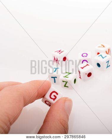 Colorful Alphabet Letter Cubes In Handon A White Background