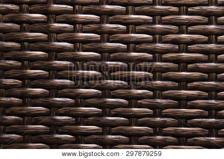 Close-up Dark Brown Background Is An Element Of Wicker Furniture Made Of Polymer Fibers. Synthetic L