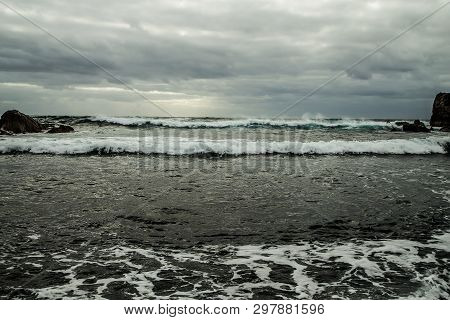 View From A Stony Shore To A Raging Ocean Wave During A Autumn Storm With A Horizon Line And Little 