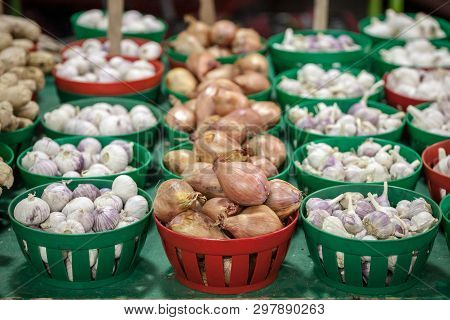 Buckets Of Red Onions And Garlic For Sale On A Canadian Market In Montreal. The Culture Of These Two