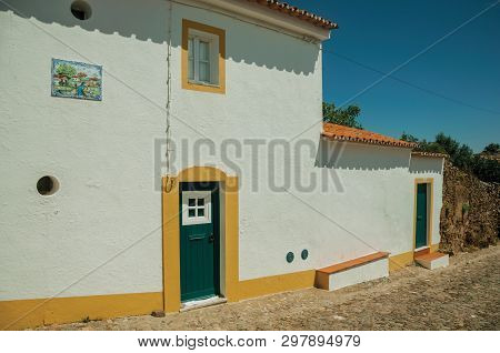 Evoramonte, Portugal - July 6, 2018. Green Wooden Doors In White Wall House, From A Street Of Evoram