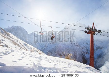 Dombai, Russia - January 3, 2014: People Are Lifting On Open Lft High Up In Caucasus Mountains