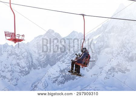 Dombai, Russia - January 3, 2014: People Are Lifting On Open Lft High Up In Caucasus Mountains