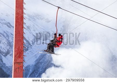 Dombai, Russia - January 3, 2014: People Are Lifting On Open Lft High Up In Caucasus Mountains