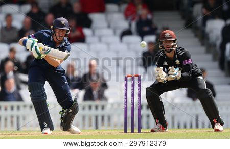 LONDON, ENGLAND. 25 APRIL 2019: Nick Gubbins of Middlesex plays a shot as wicketkeeper Ben Foakes of Surrey looks on  during the Surrey v Middlesex, Royal London One Day Cup match at The Kia Oval. 