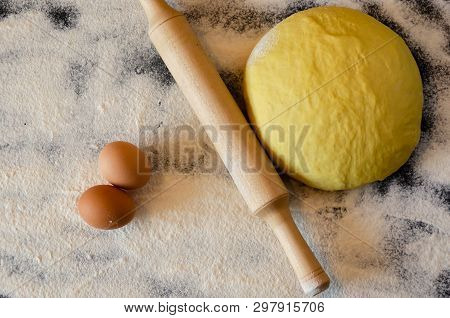 Dough And Rolling Pin On A Floury Table