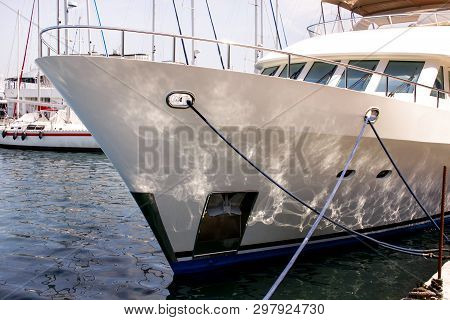 Bow Of Large Modern Luxury White Yacht And Ship Anchored In Harbor, Close Up. Large White Modern Mot