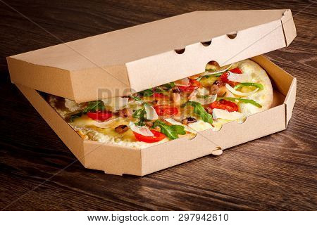 Clean Top Surface Open Pizza Box With Tasty Colorful Pizza Inside. On A Brown Wooden Table. Copy Spa