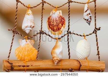 Sea Handmade Decoration, Souvenir. Colour Seashells Decorated Of Rope And Bamboo In Shape Of A Fishi