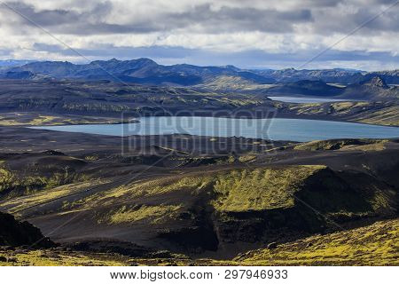 Dramatic Iceland Landscape Of Craters Of Laki Volcanic Fissure With A Green Hill And Black Lava Look