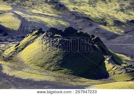 Dramatic Iceland Landscape Of Craters Of Laki Volcanic Fissure With A Green Hill And Black Lava Look