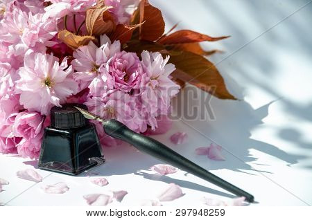 Old Ink Pen And Ink Bottle On White Background. Vintage Calligraphy Pen And Bottle Of Ink. Selective