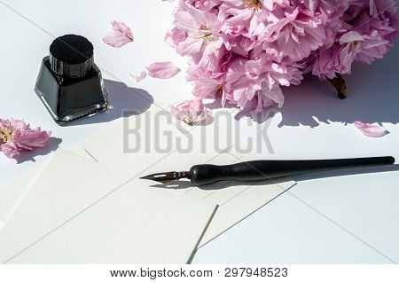 Old Ink Pen And Ink Bottle On White Background. Vintage Calligraphy Pen And Bottle Of Ink. Selective