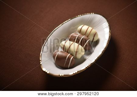 Delicious and exotic gourmet date- chocolates served in a small plate. Chocolate coated date fruit is an Emirati special sweet.