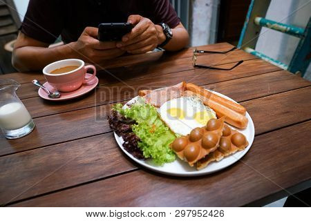 Big Hot Breakfast Wiht Fried Eggs, Sausages, Ham, Waffle And Salad