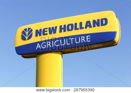 Hadsten, Denmark - May 5, 2018: New Holland Agriculture Logo On A Pole. New Holland Is A Brand Agric