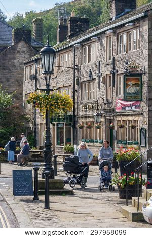 Uppermill, Oldham, Uk - September 21st 2010: People Wheeling Prams Past The Swan Public House On A S