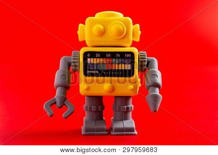Rubber Toy Robot On A Red Background