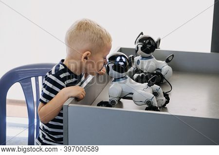 Little Boy Playing With Interactive Remote Control Robot Dog Toy. Kid And Smart Dancing Robot Toy, I