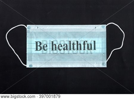 Protective Medical Mask Isolated On Black Background. Be Healthful. Protection From Covid-19. Non-pe