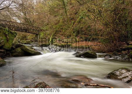 Long Exposure Of The East Lyn River Flowing Under A Bridge At Watersmeet In Exmoor National Park In 