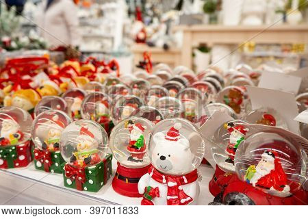 Glass Christmas Toys, Souvenirs - Snowballs On The Counter. Snow Globes With Christmas Or Winter The