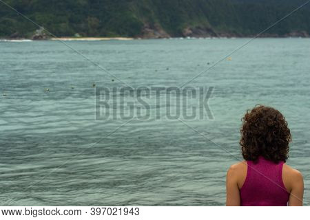 View Of A Young Woman Looking At The Sea With Selective Focus And Copy Space.