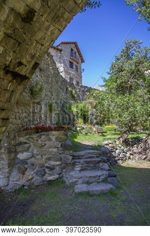 A Mountain Village House Built In Stone And A Garden Decorated With Flowers, On A Summer Day, Sallen