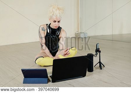 Serious Professional Female Dancer Setting Computer, Smartphone And Tablet To Host Online Dance Less