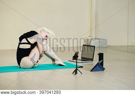 Attractive Fit Young Woman Filming Her Dance Video On Smartphone In Class