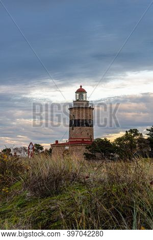 Falstebo, Sweden - November 15, 2020: A Brick Lighthouse With A Bright Blue Sky In The Background. P