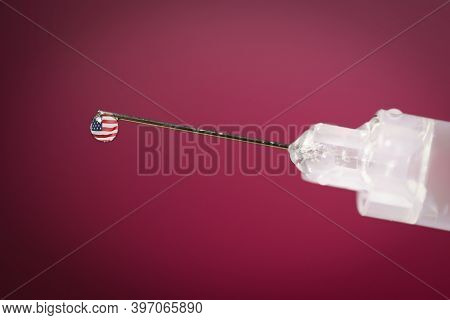 Close-up Of A Drop In A Syringe With The United States Flag Waving Inside.