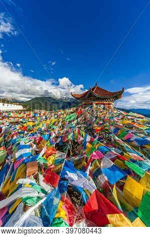 Dêqên, China - 08 17 2009: Tibetan Buddhist Prayer Flags Hanging From A Pagoda Overlooking The Kawa 