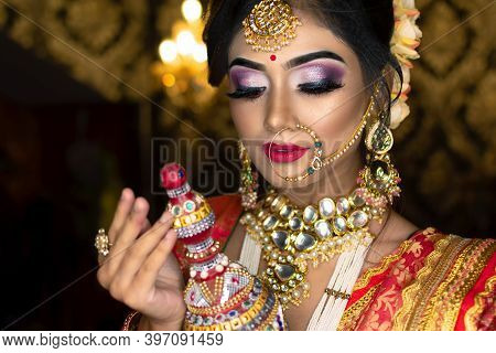Portrait Of Very Beautiful Indian Bride Holding Traditional Wooden Sindur Or Sindoor Box In Hand, We