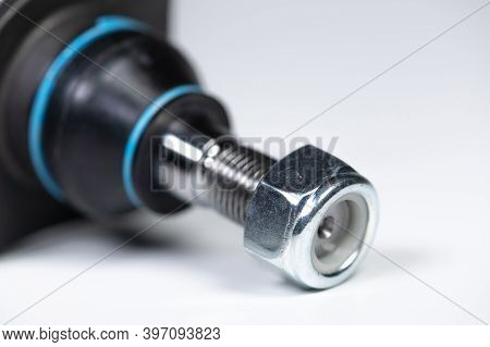 Ball Joint Car Suspension On A Gray Background. New Spare Parts Axel Car Elements