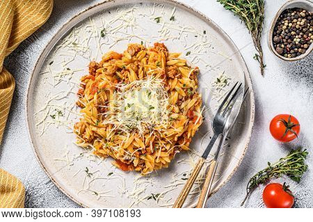 Orzo Pasta, Risone With Bolognese Sauce And Ground Beef In A Plate. Gray Background. Top View