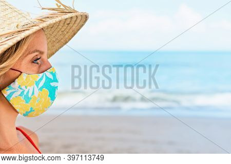 Funny Portrait Of Young Woman In Straw Hat On Tropical Sea Beach. New Rules To Wear Cloth Face Cover
