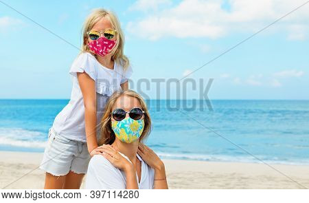 Mother, Child In Stylish Masks Have Fun On Sea Sand Beach. New Rules To Wear Face Covering At Public