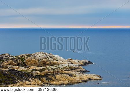 Beautiful Seascape Of Small Island In Barents Sea With Motorboats.