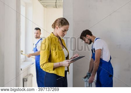 Famele Brigadier Evaluate The Work Of Repairers And Write In The Clipboard