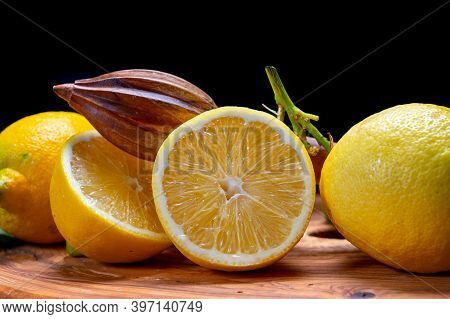 Fresh Ripe Yellow Italian Lemons And Wooden Juice Squeezer, New Harvest